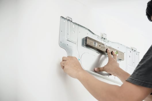 Technician is installing air conditioner during hot season photo