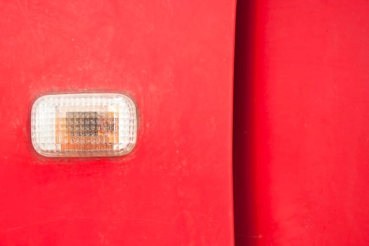 Car turn signal lights - doors - old classic red cars being repaired and recycled. photo