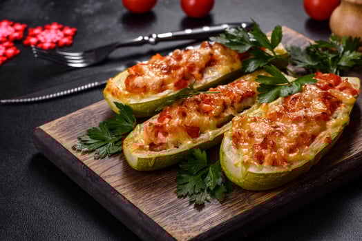 Baked stuffed zucchini boats with minced chicken mushrooms and vegetables with cheese. Christmas table photo