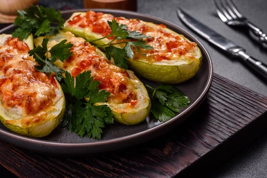 Baked stuffed zucchini boats with minced chicken mushrooms and vegetables with cheese photo