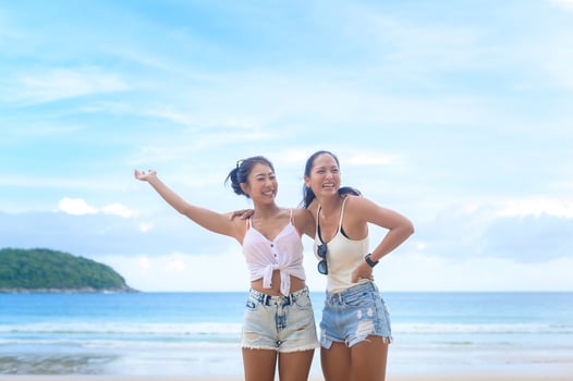 Two attractive women friends enjoying and relaxing on the beach,  Summer, vacation, holidays, Lifestyles concept. photo