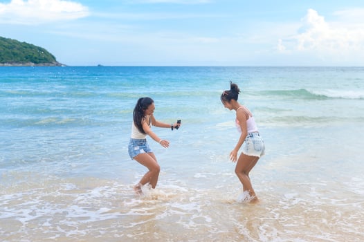 Two attractive women friends enjoying and relaxing on the beach,  Summer, vacation, holidays, Lifestyles concept. photo
