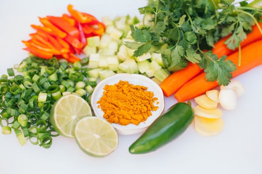 Fresh vegetable assortment on white background. Greenery, cut limes, pepper, carrot, cucumber and lime. Healthy nutrition concept. Vegeterian products photo