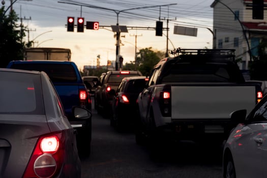 Abstract and blurred of rear side  cars stop on the asphalt road by traffice control red color in Thailand. Traffic congestion. long queues in the evening. photo