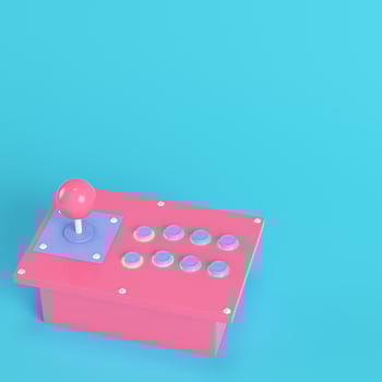 Retro arcade game controller on bright blue background in pastel colors photo