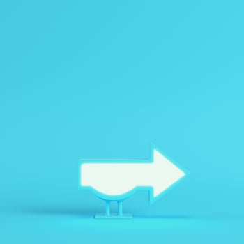 Billboard in arrow shape on bright blue background in pastel colors. Minimalism concept photo