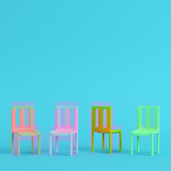 Four chairs on bright blue background in pastel colors. Minimalism concept photo
