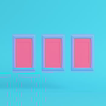 Pink blank frames on bright blue background in pastel colors photo