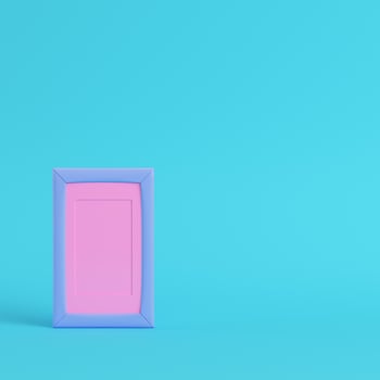 Pink blank frame on bright blue background in pastel colors photo