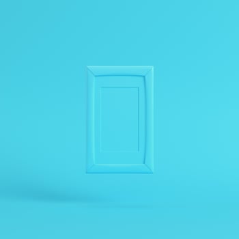 Blank frame on bright blue background in pastel colors photo