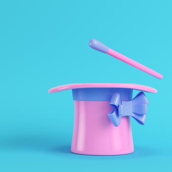 Top hat and magic wand on bright blue background in pastel colors photo
