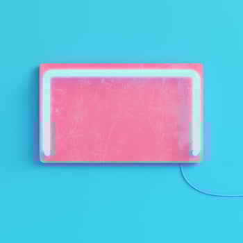Pink plate with neon light on bright blue background in pastel colors photo
