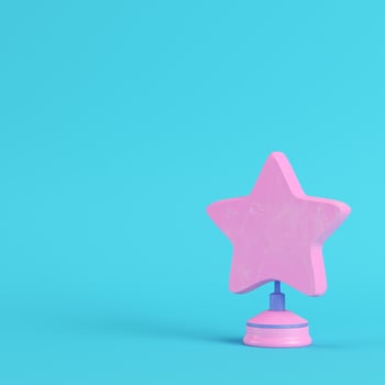 Star with stand on bright blue background in pastel colors. Minimalism concept photo