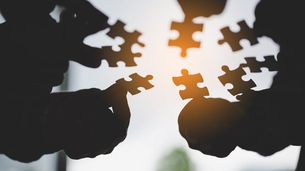 hand of business people connecting jigsaw puzzle photo