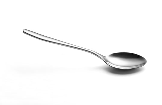 The metal shiny spoon isolated on white photo