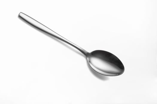 The metal shiny spoon isolated on white photo