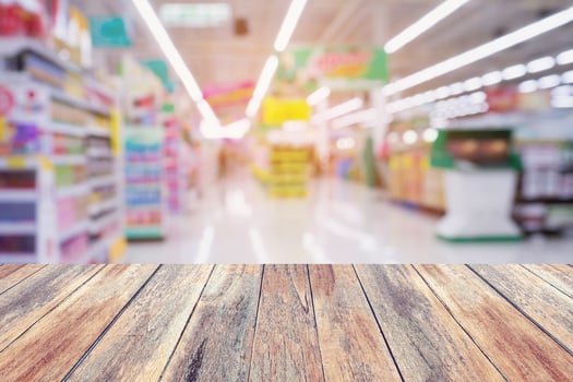 Supermarket store abstract blur background with wood table photo