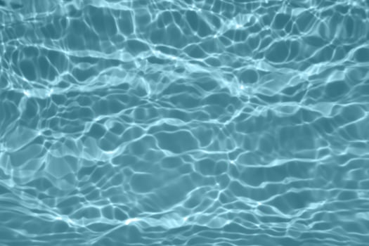 Defocus blurred blue watercolor in swimming pool rippled water detail background. Water splash, water spray background. photo