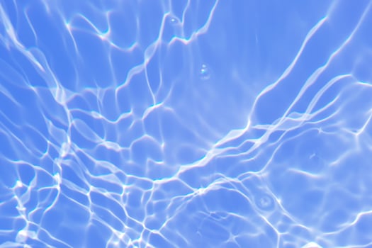 Defocus blurred blue watercolor in swimming pool rippled water detail background. Water splash, water spray background. photo
