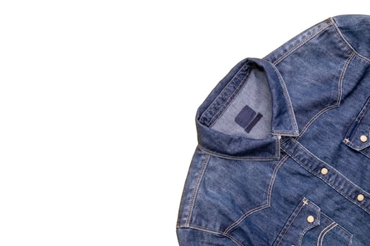Top view new blue jean jacket isolated on white photo