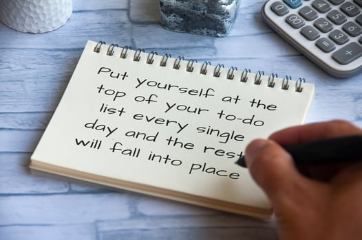 Life inspirational quote - Put yourself at the top of your to-do list every single day and the rest will fall into place. Hand writing on notepad photo