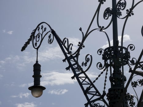 backlit details of a modernist chandelier in the city of Barcelona photo