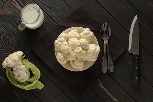 Raw, fresh organic cauliflower on a wooden background. Healthy eating, low carb diet concept photo