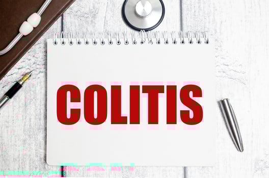 colitis word and stethoscope on wooden background photo