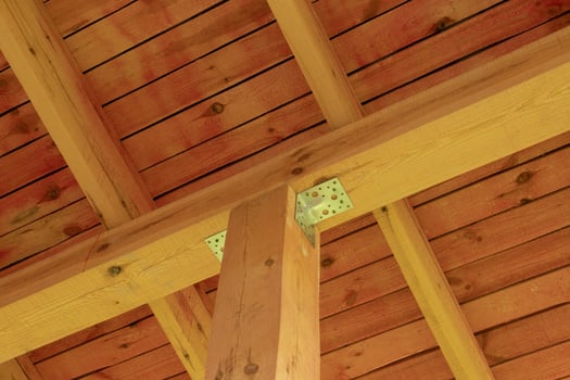 Interior view of a wooden roof structure with beams. photo