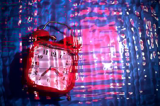 Abstract blurry background with a clock. Time concept in blue and pink. Drowning clock. photo