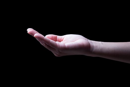 woman hands palms up over black background photo