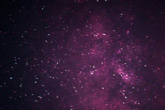 Colorful galaxy with dominant red and purple with star galaxy in outer space photo