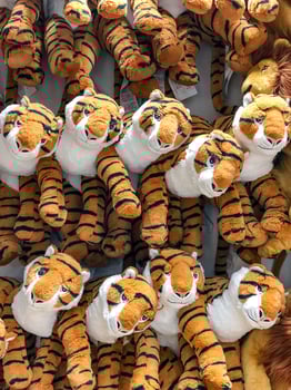 tiger dolls hang on to the wall for sales in kid depart at departmentstore. photo
