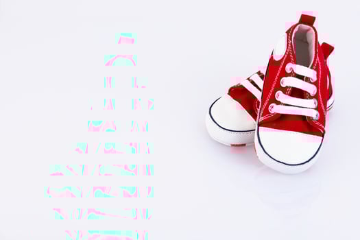 Baby red sneakers isolated on white background. Children's shoes store. Copy space. photo