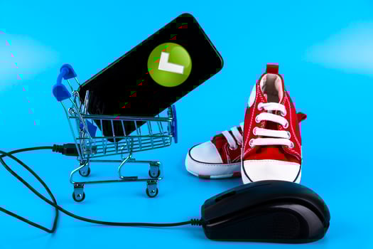 online store of children's shoes, red sneakers on a blue background. Copy space. photo