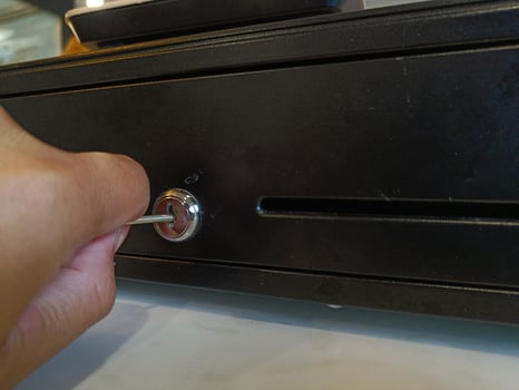 Burglar try stealing money from cash register photo