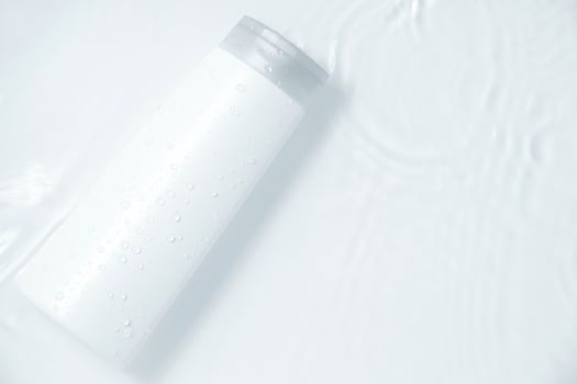 beauty fashion cosmetic makeup bottle lotion cream product with skincare healthcare concept on water splash background photo