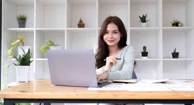 Portrait of smiling beautiful business asian woman working in modern office desk using tablet laptop computer, Business people employee freelance online marketing e-commerce telemarketing concept. photo