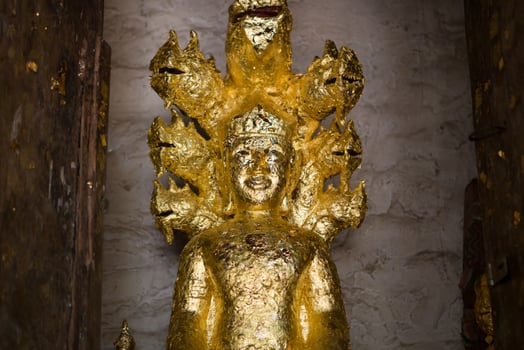 close up Buddha statue gilded in the measure photo