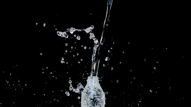 Abstract water jet crashes on a black background photo