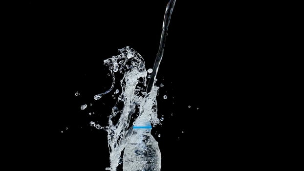 Abstract water jet crashes on a black background photo