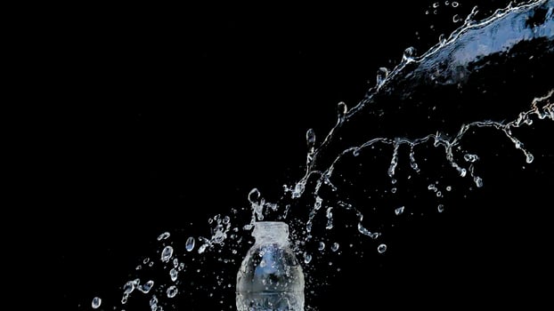 Abstract water jet crashes on a black background photo