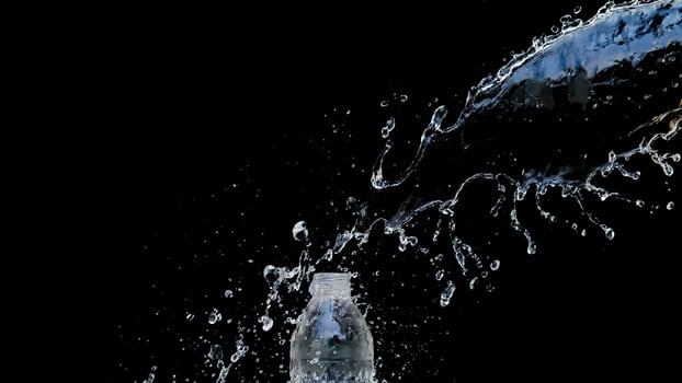 Abstract water jet crashes on a black background photo