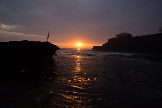 sunset over hindu temple Pura Tanah Lot, Bali, Indonesia photo