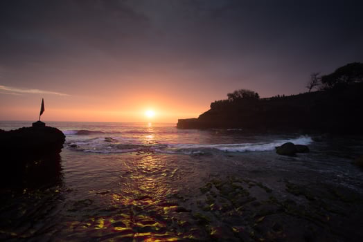 sunset over hindu temple Pura Tanah Lot, Bali, Indonesia photo