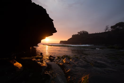 sunset over hindu temple Pura Tanah Lot, Bali, Indonesia photo