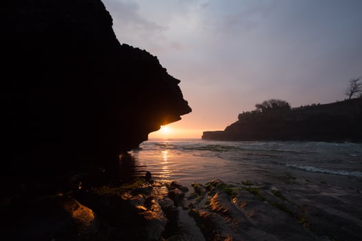 sunset over hindu temple Pura Tanah Lot, Bali, Indonesia photo