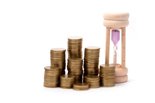 Hourglasses and columns of coins photo