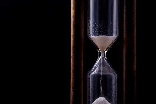 sand falling in hour glass photo