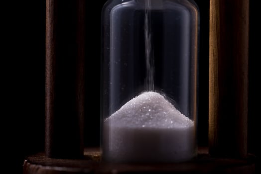 sand falling in hour glass photo
